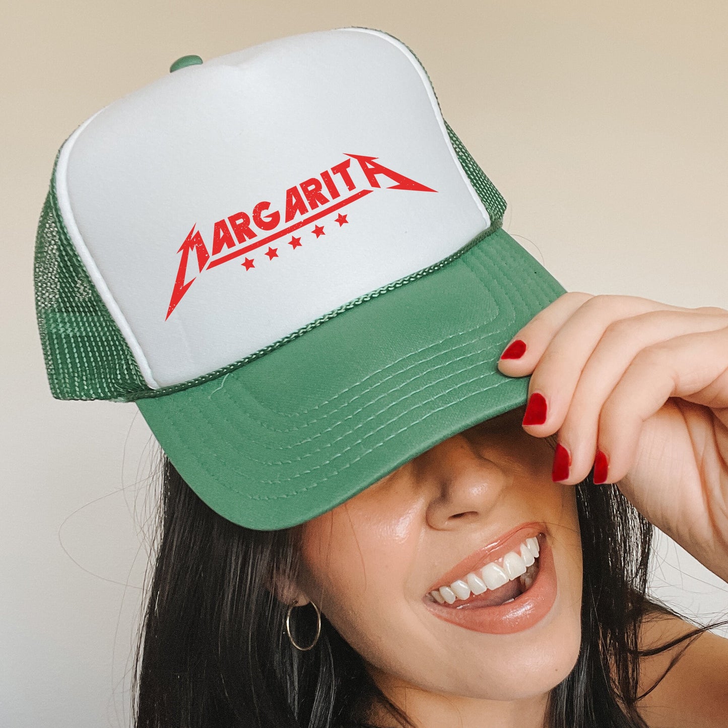 a woman wearing a green and white trucker hat