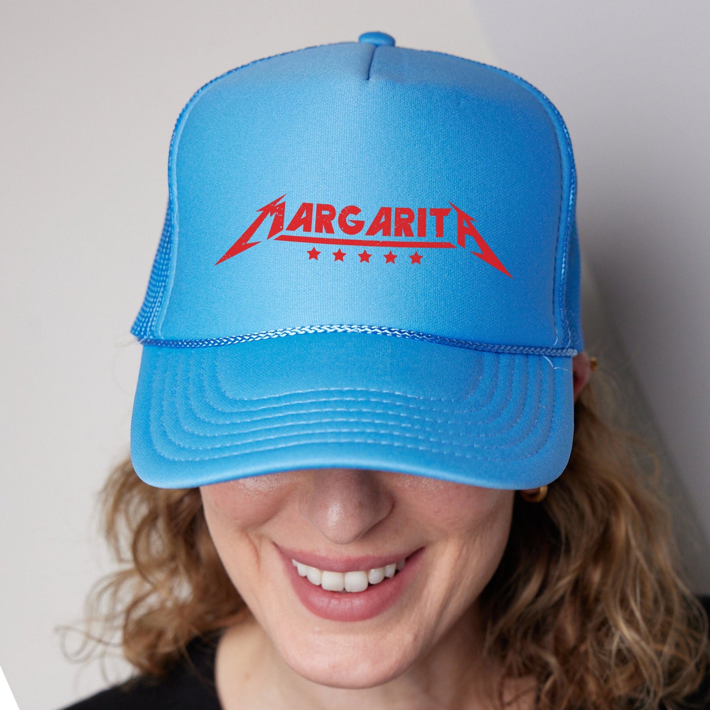 a woman wearing a blue hat with a red logo on it