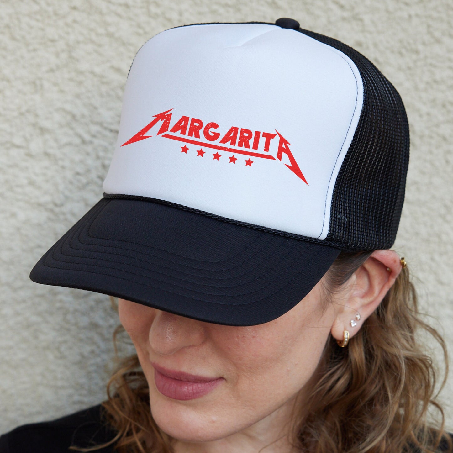 a woman wearing a black and white hat with a red logo