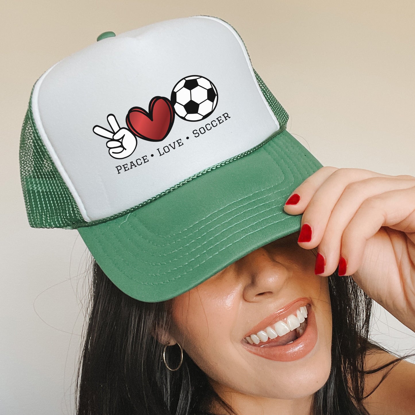 a woman wearing a green and white trucker hat