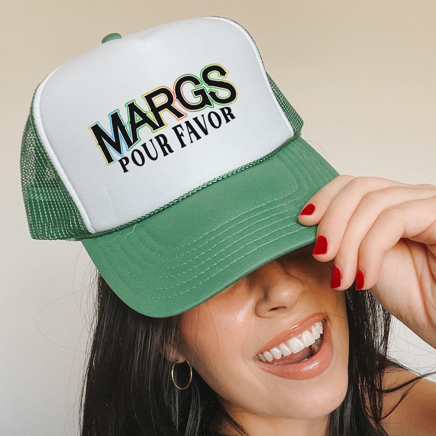 a woman wearing a green and white trucker hat