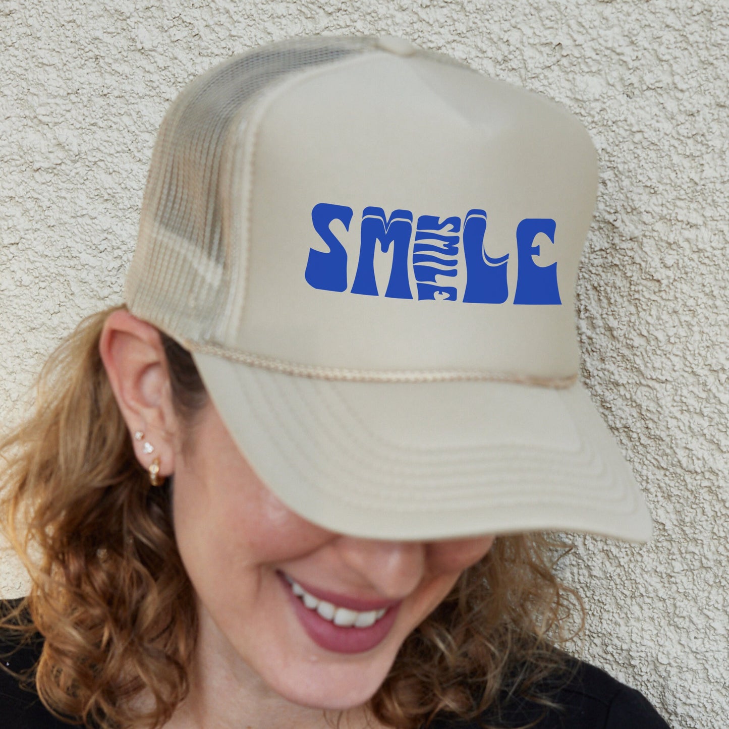 a woman wearing a hat with the word smu on it
