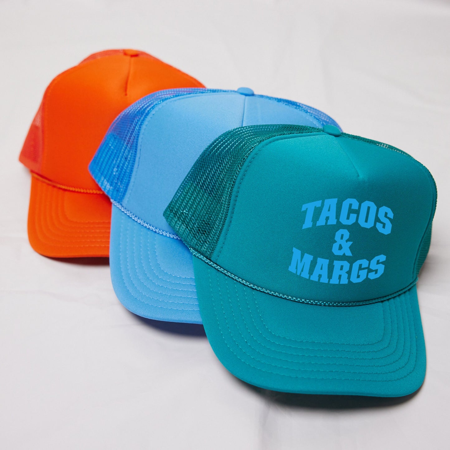 a couple of hats sitting on top of a white table