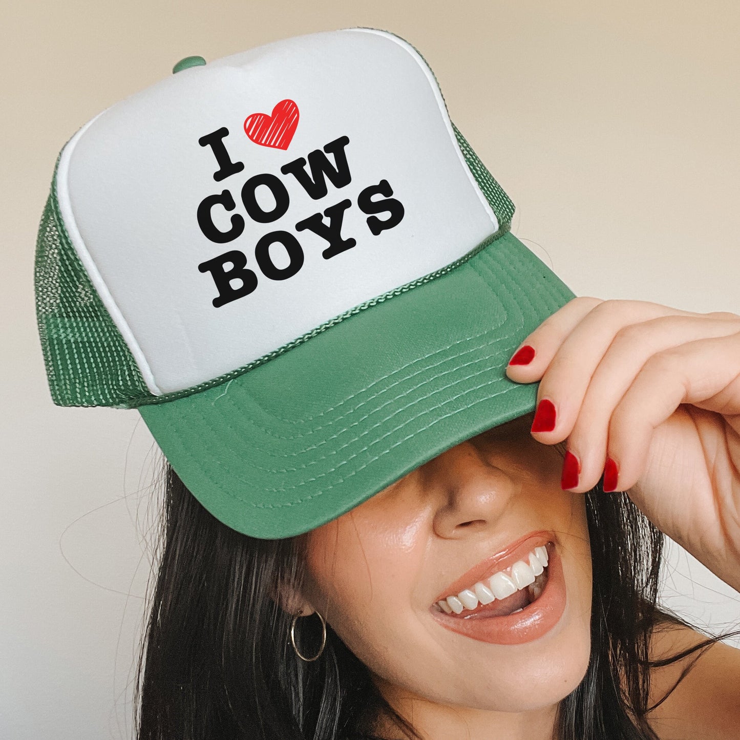 a woman wearing a green and white trucker hat