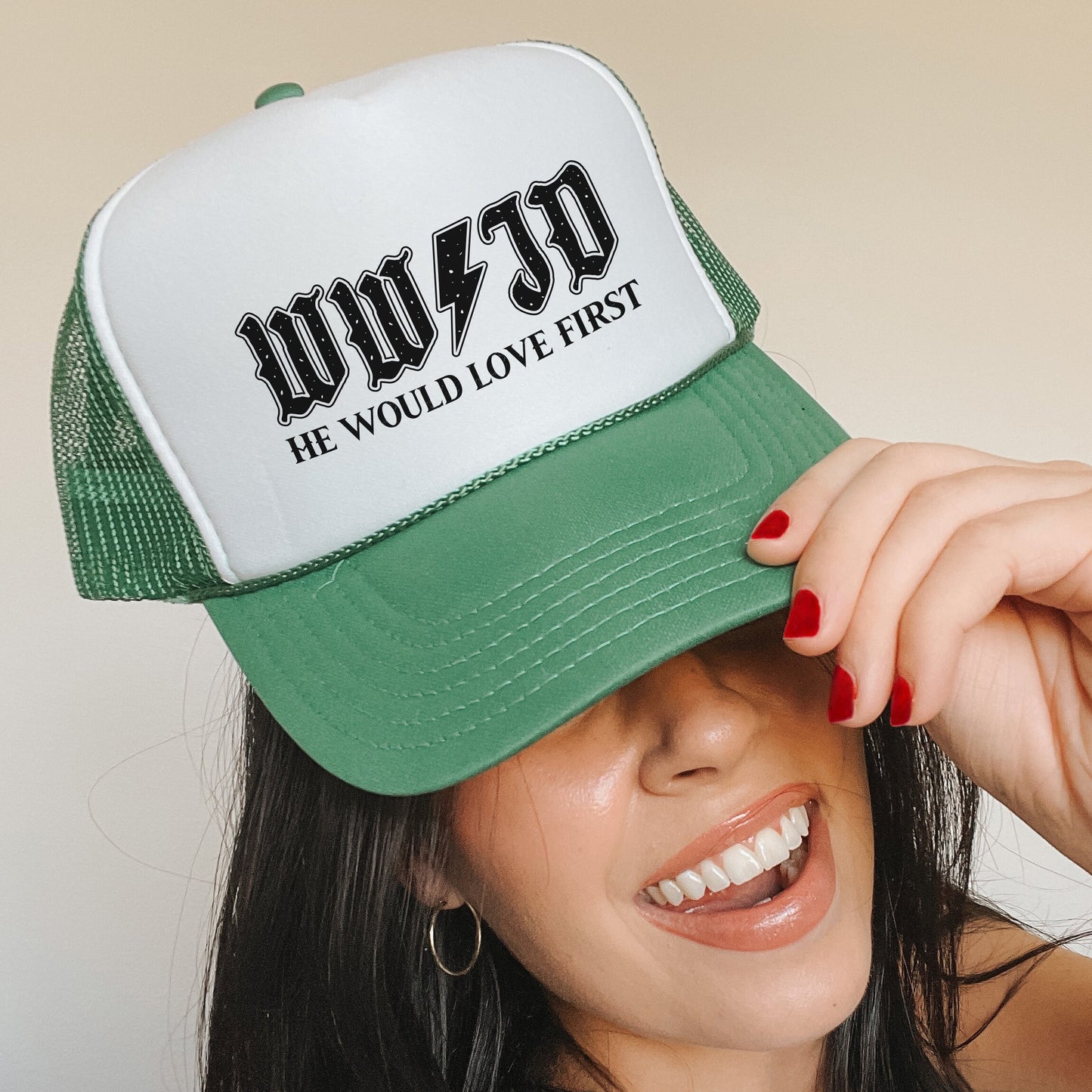 a woman wearing a green and white trucker hat