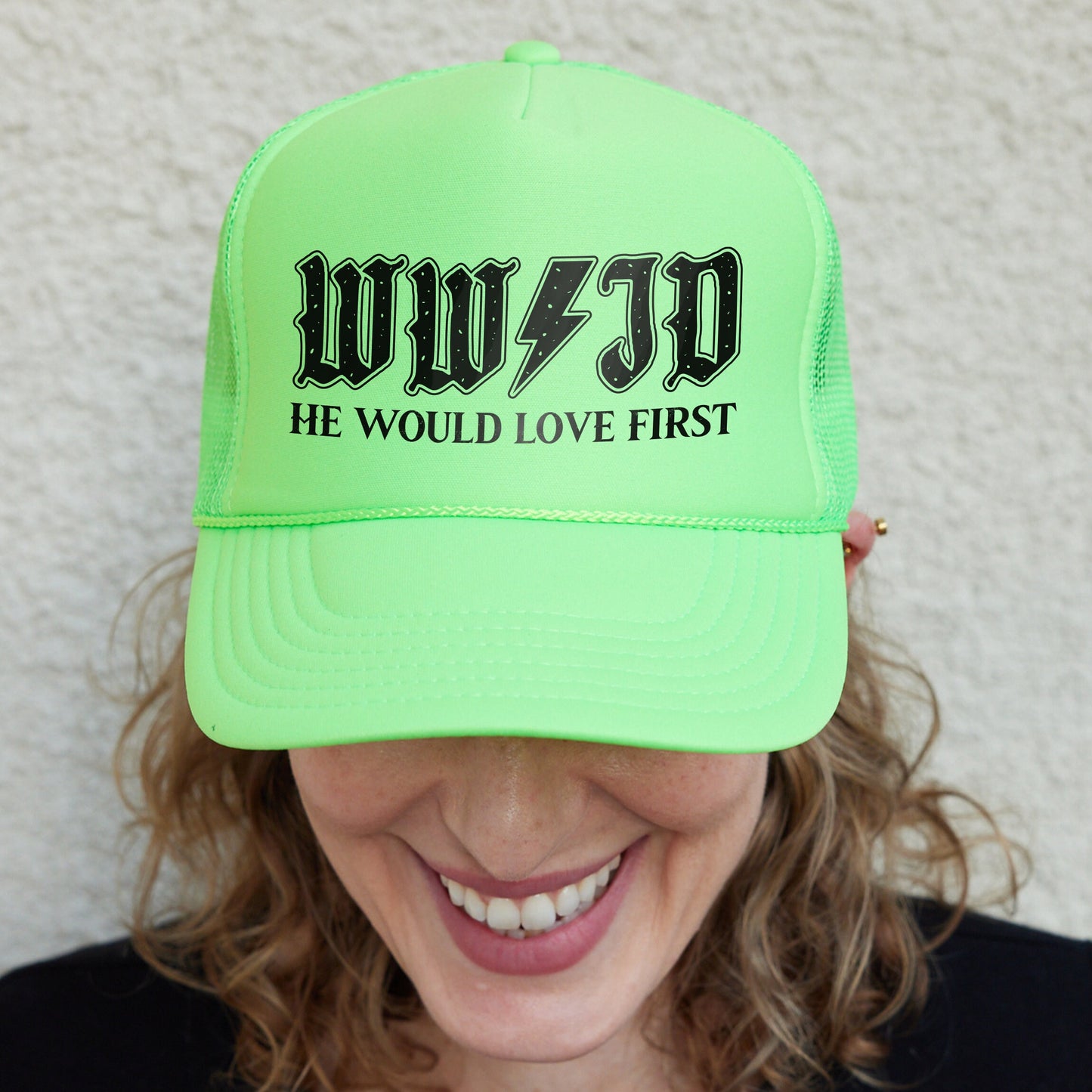 a woman wearing a neon green hat with the words wuf - d he would