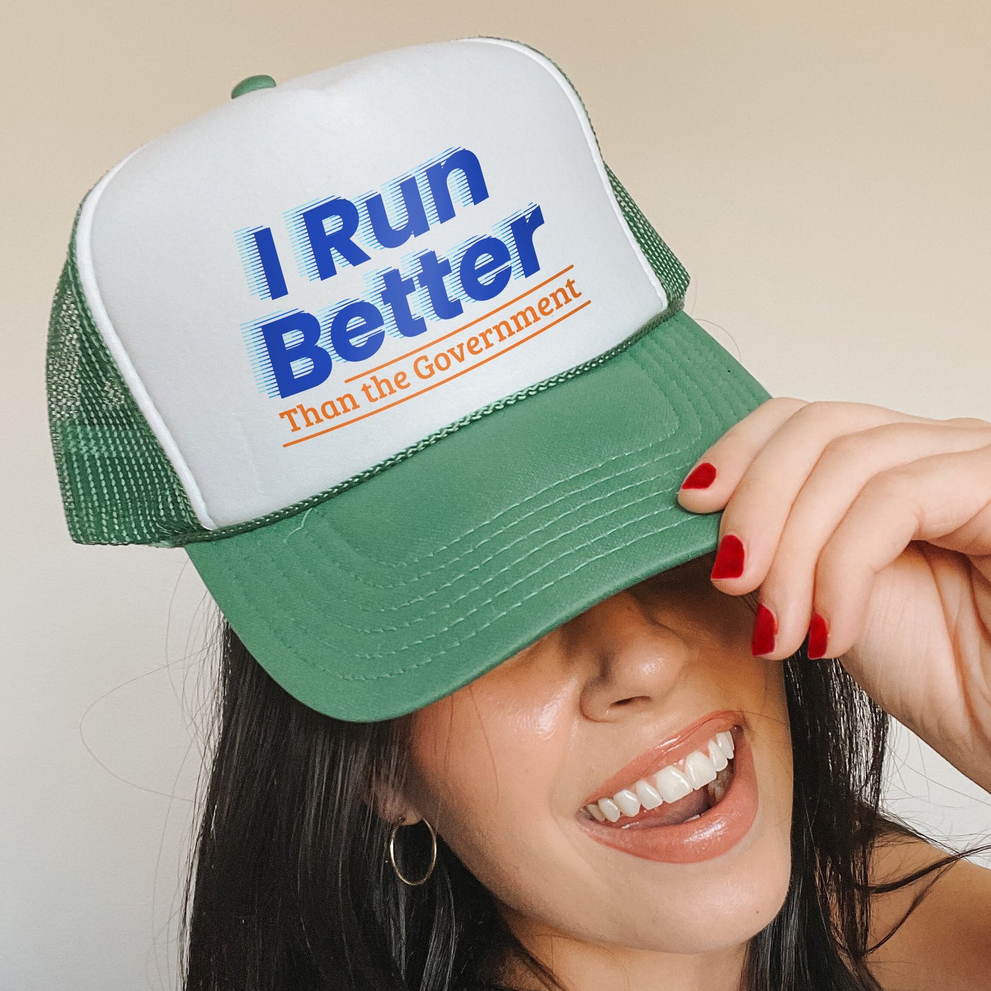 a woman wearing a hat that says i run better than the government