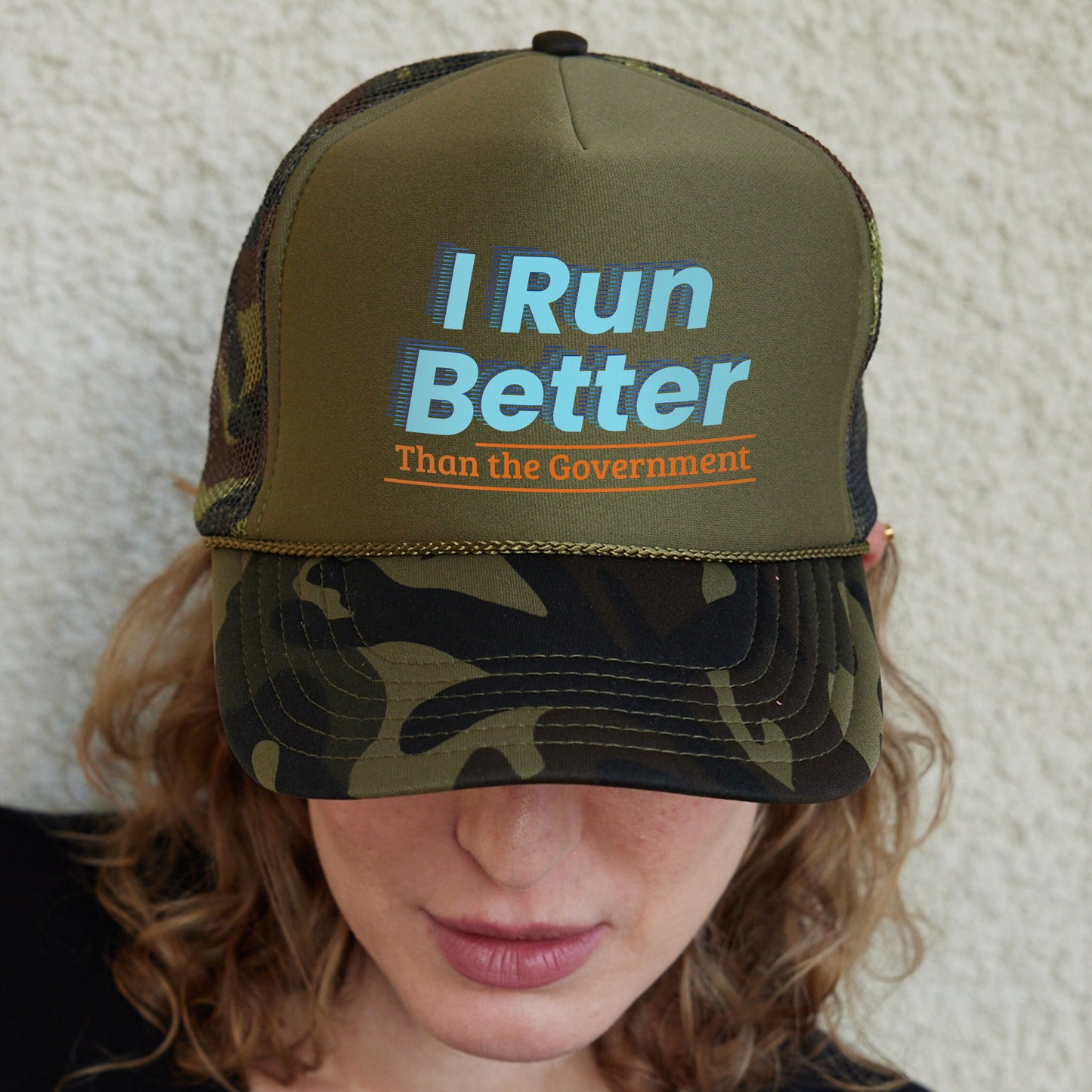 a woman wearing a hat that says i run better than the government