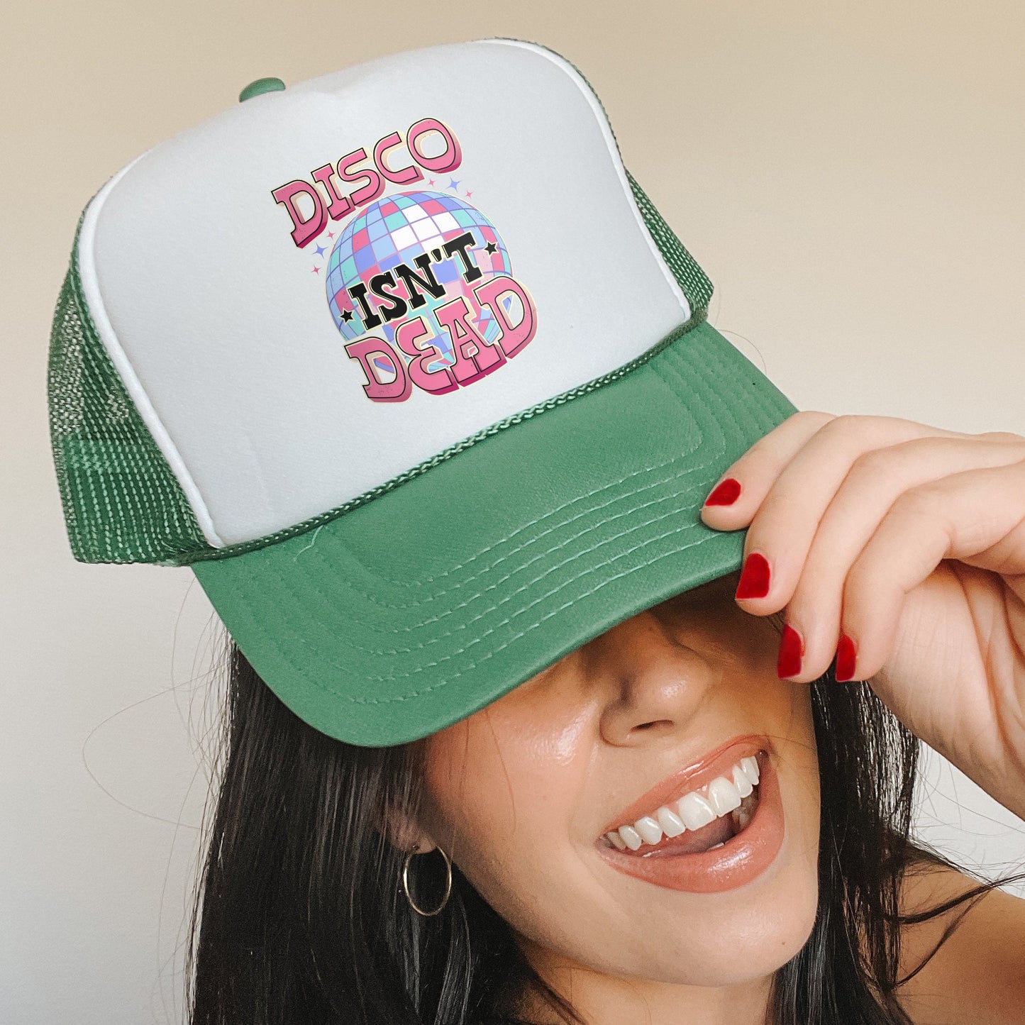 a woman wearing a green and white disco hat