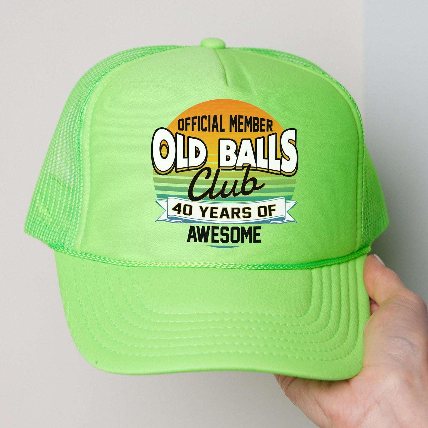 a green trucker hat with an old ball club logo