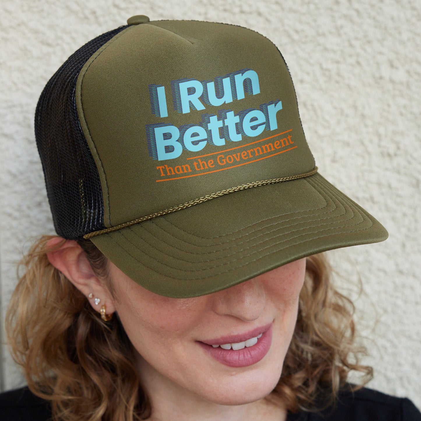 a woman wearing a hat that says i run better than the government