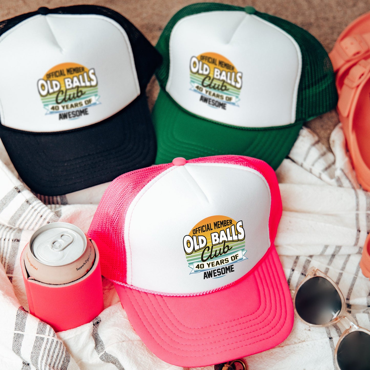 three old balls hats and sunglasses on a towel