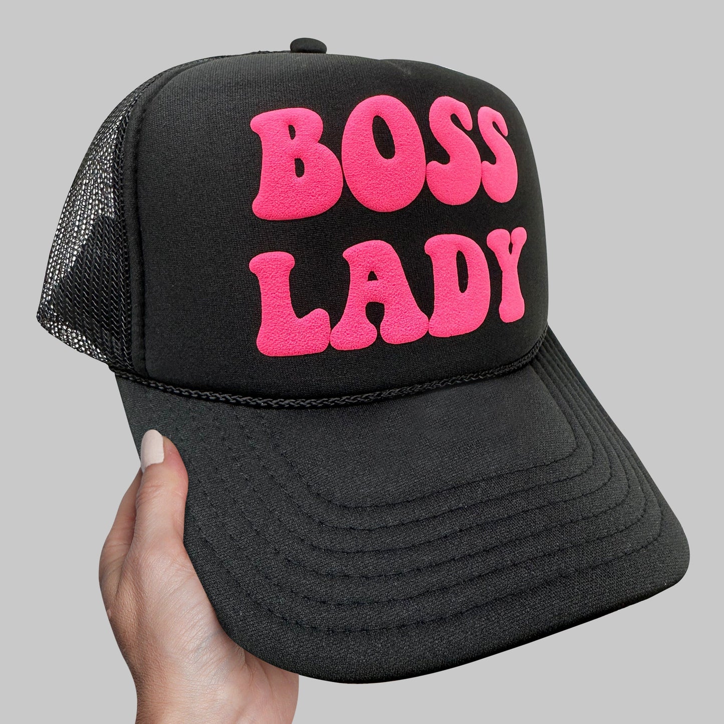a black and pink hat with the words boss lady printed on it