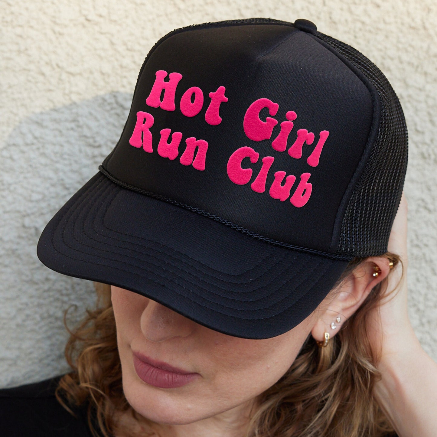 a woman wearing a black hat with hot girl run club written on it