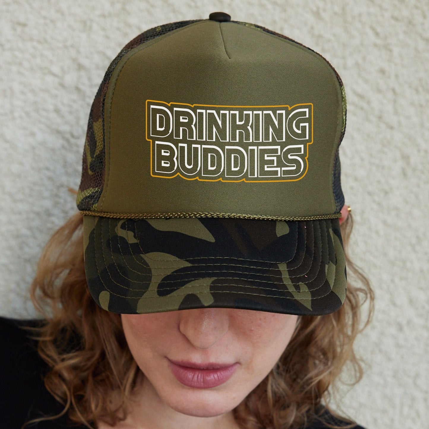 a woman wearing a hat with the words drinking buddies on it