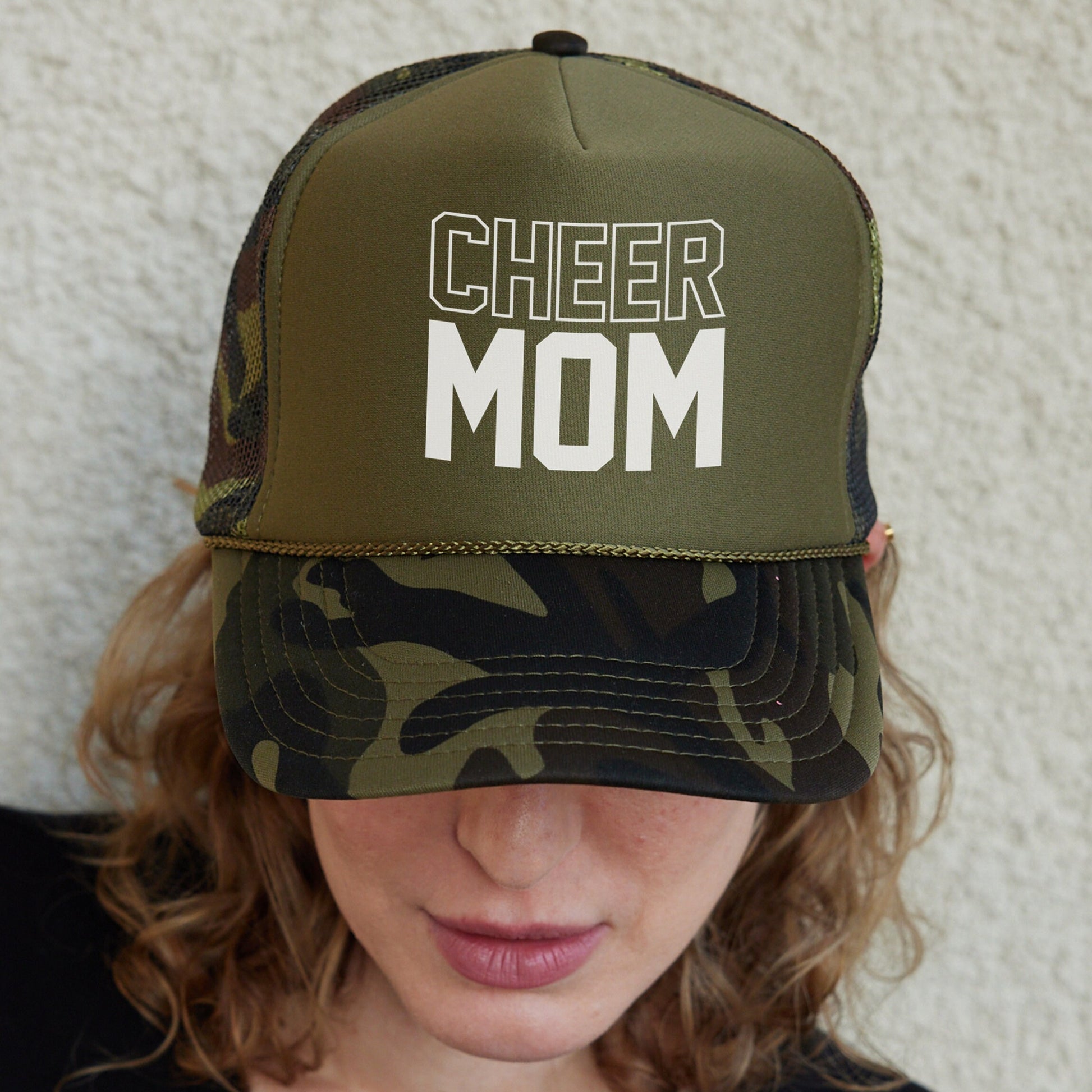 a woman wearing a hat that says cheer mom