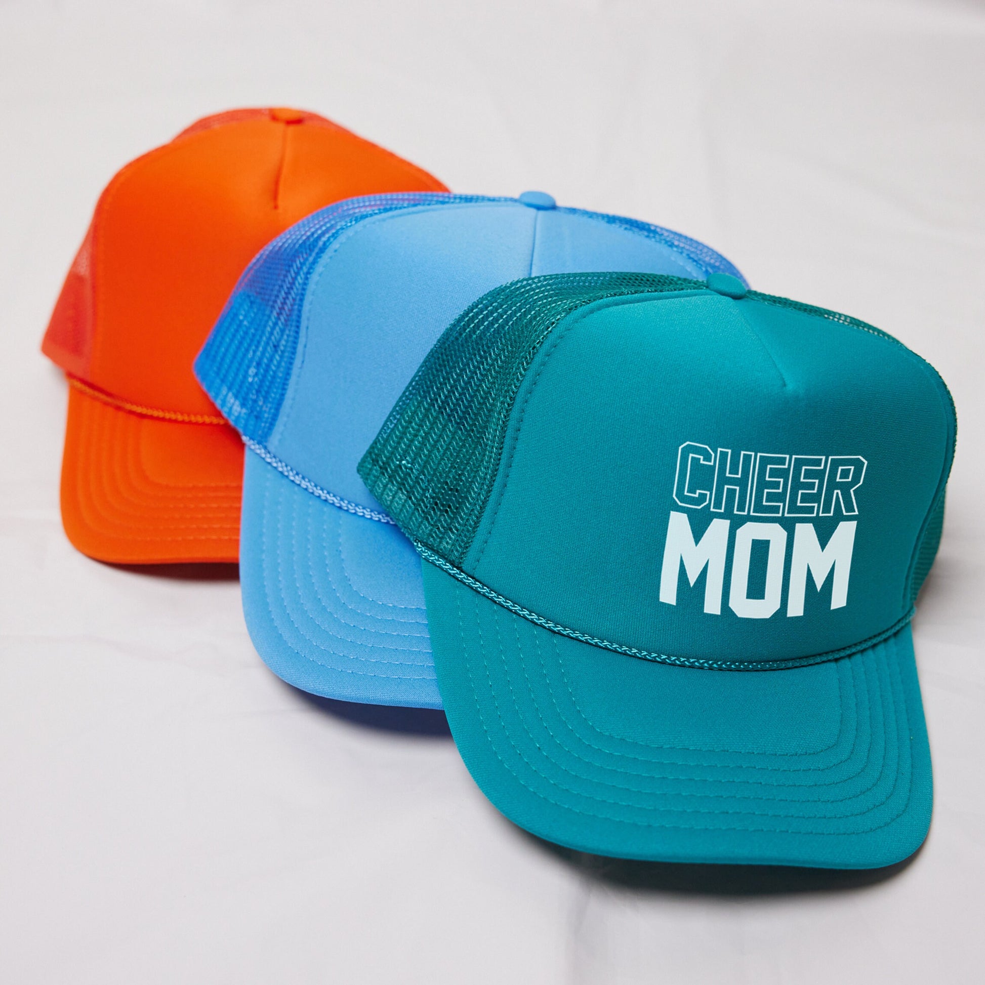 three hats with the word cheer mom on them