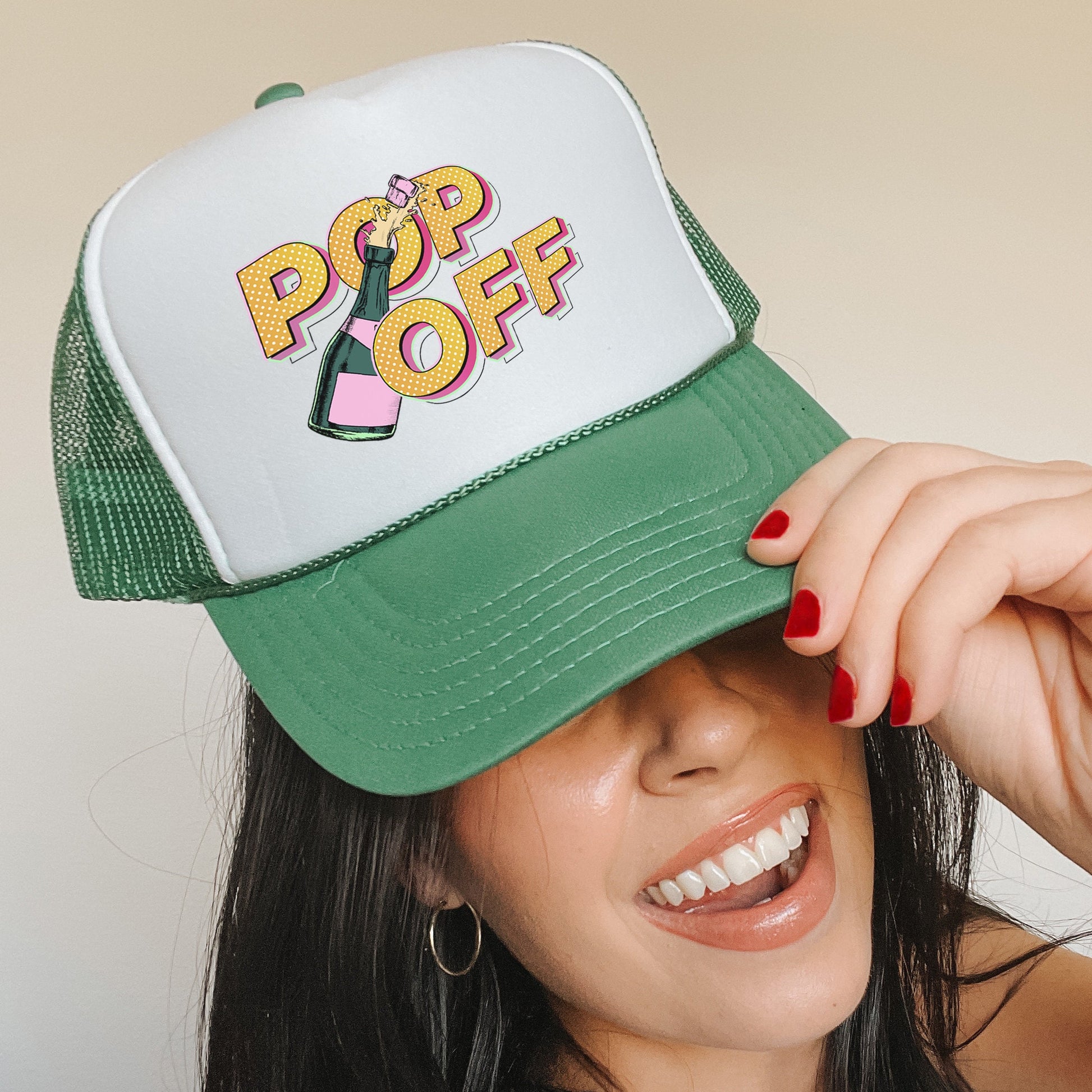 a woman wearing a green and white hat with pop off on it