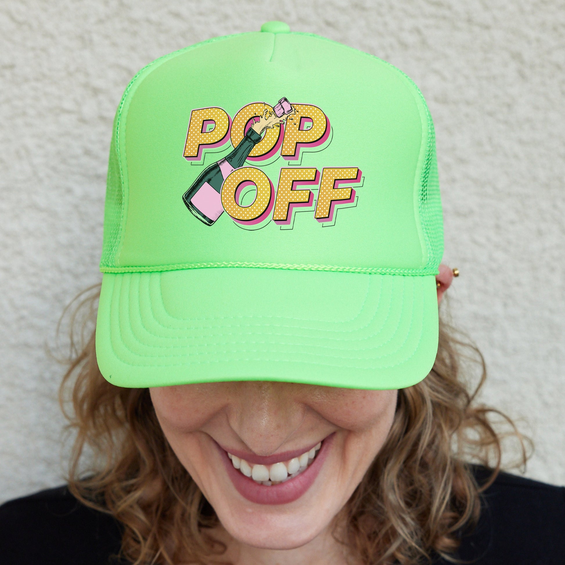 a woman wearing a neon green hat with pop off on it