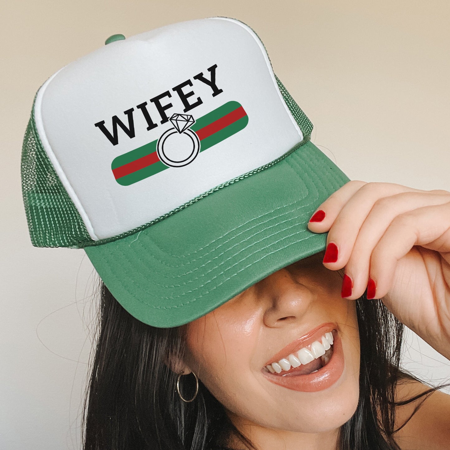 a woman wearing a green and white trucker hat