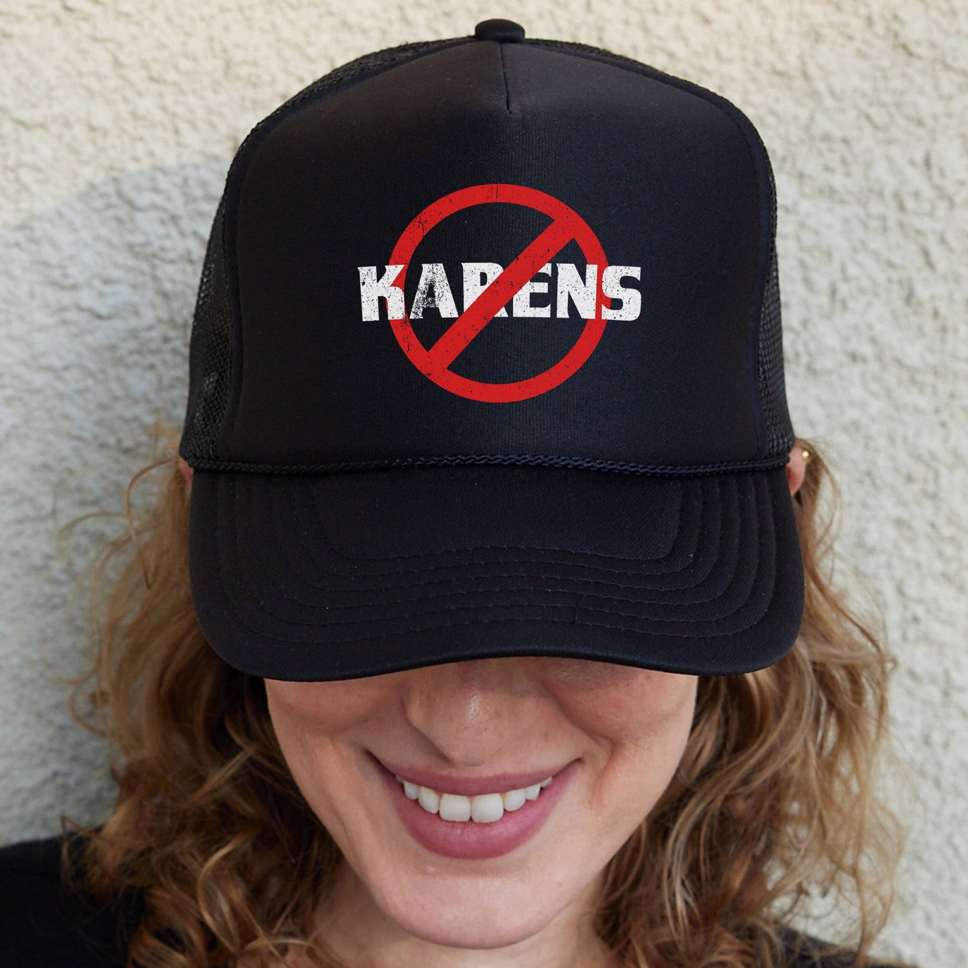 a woman wearing a black hat with a no kapen sign on it