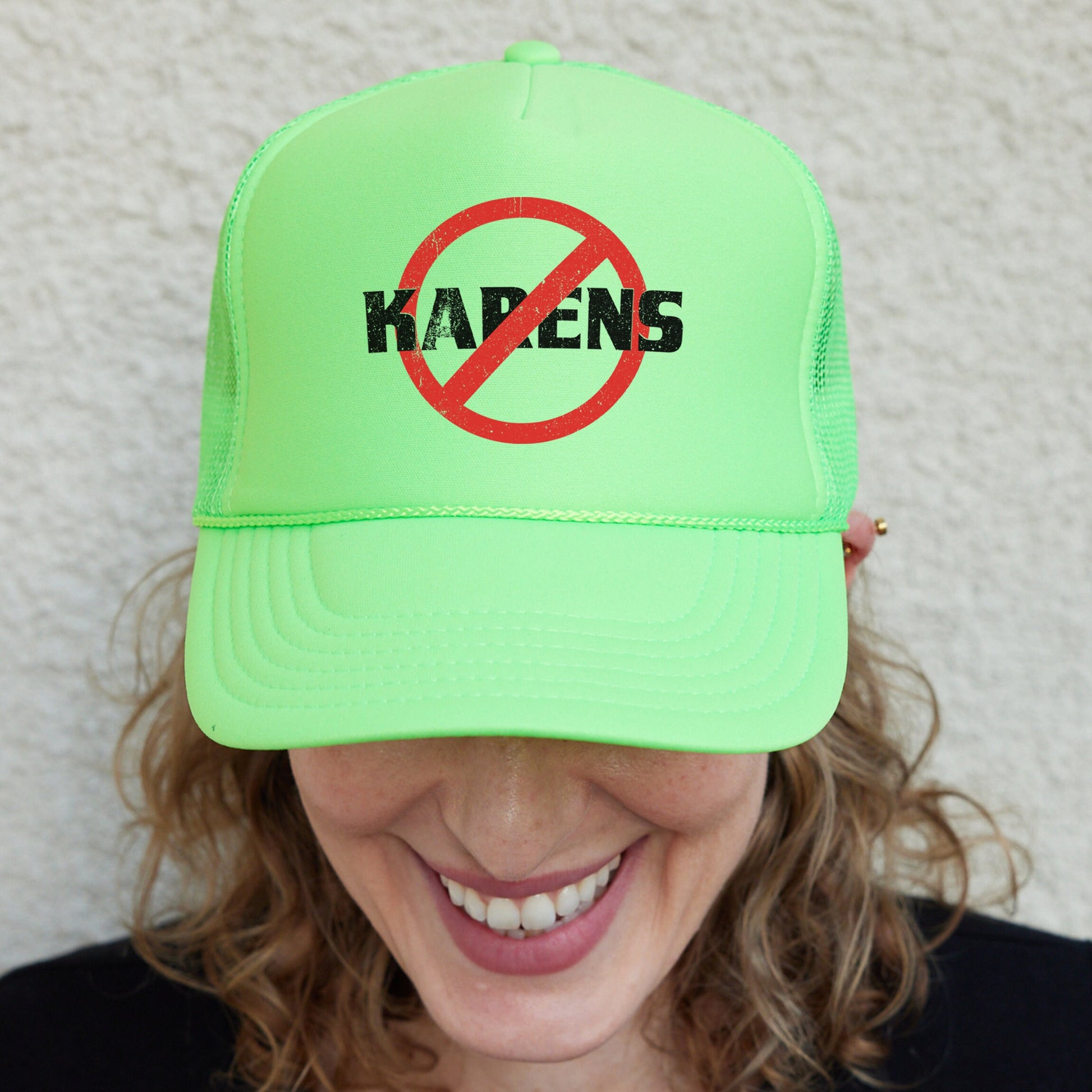 a woman wearing a neon green hat with a no kalen sign on it