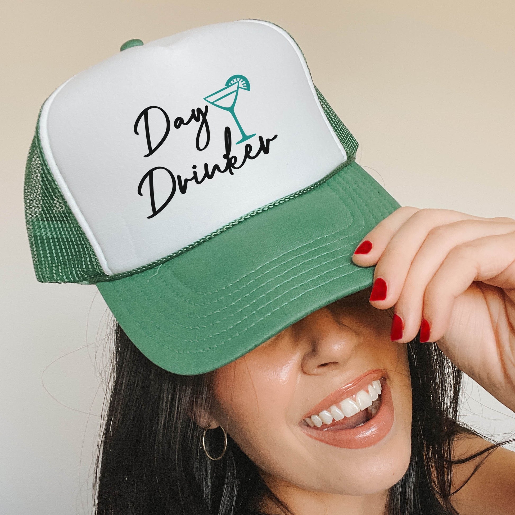a woman wearing a green and white trucker hat