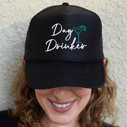 a woman wearing a black hat with the words day drinker on it