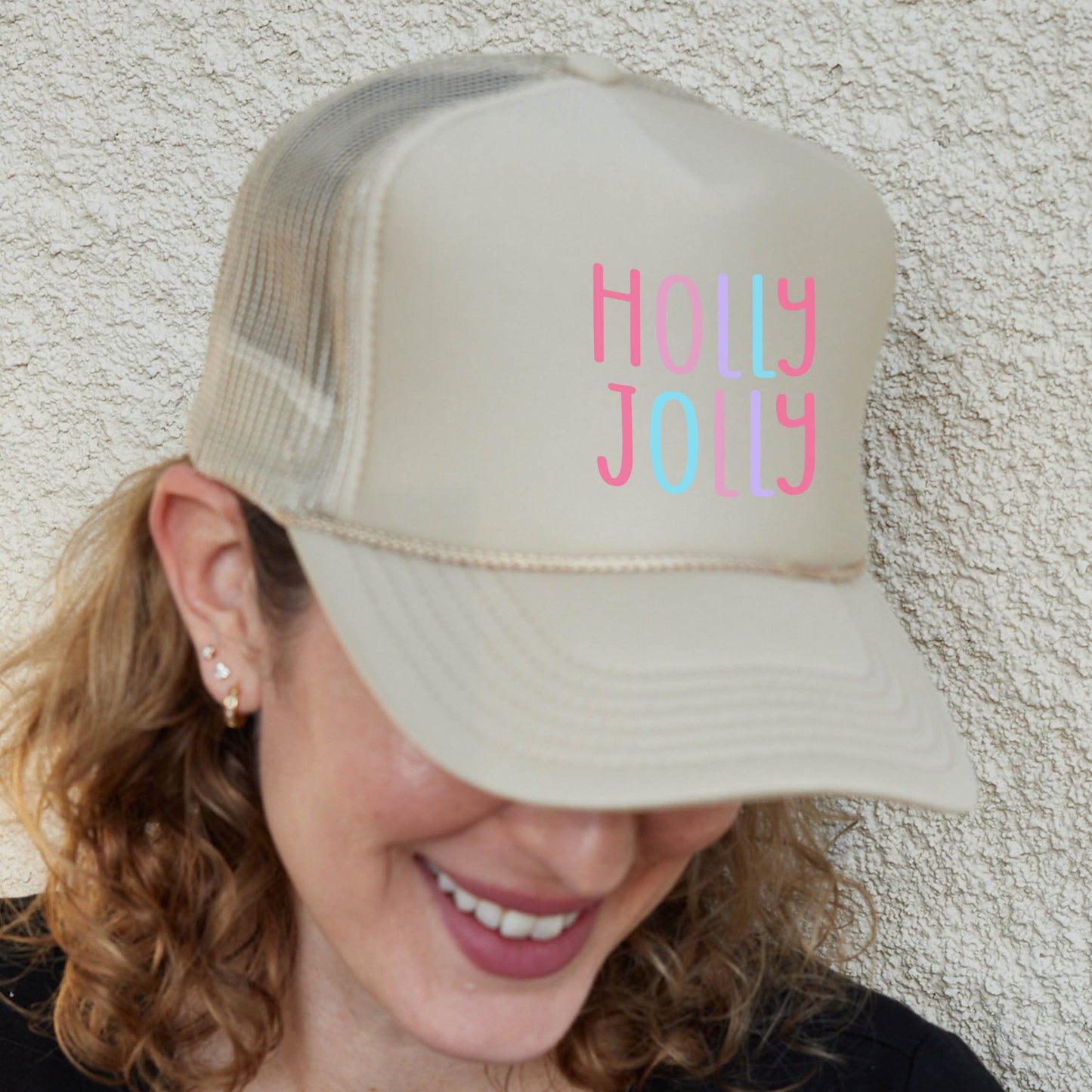 a woman wearing a trucker hat with the words holy joy on it