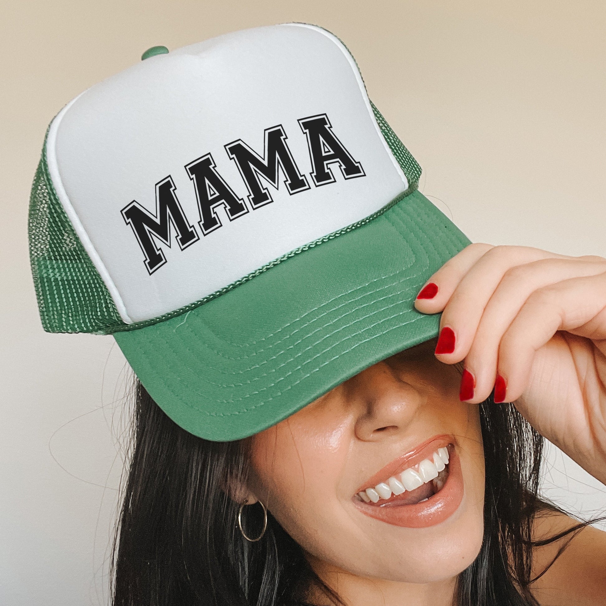 a woman wearing a green and white trucker hat