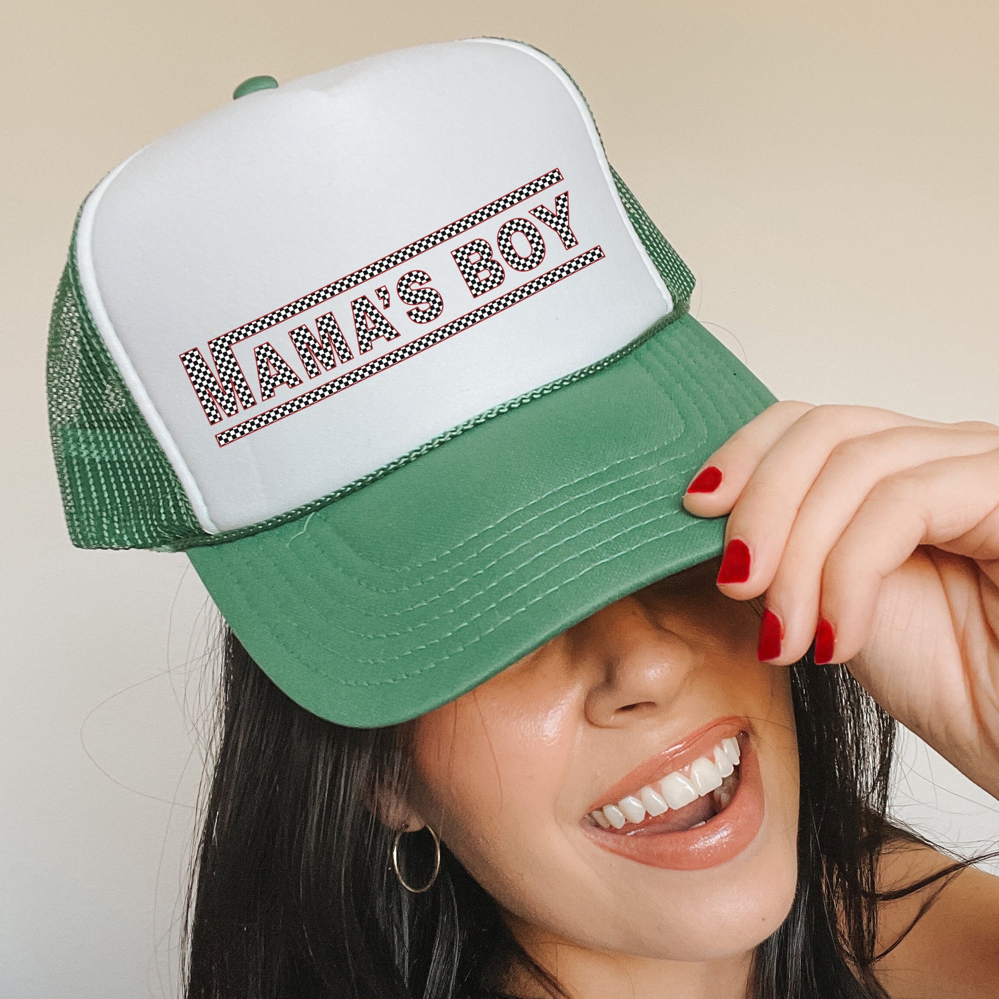 a woman wearing a green and white trucker hat