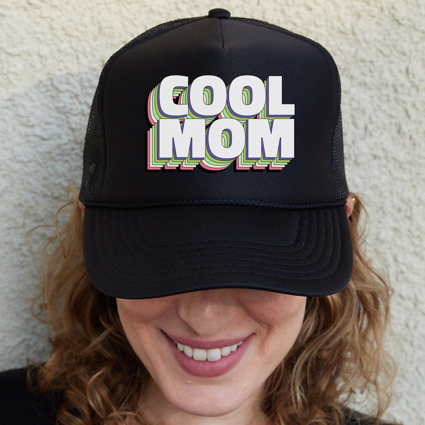 a woman wearing a black hat with the words cool mom on it