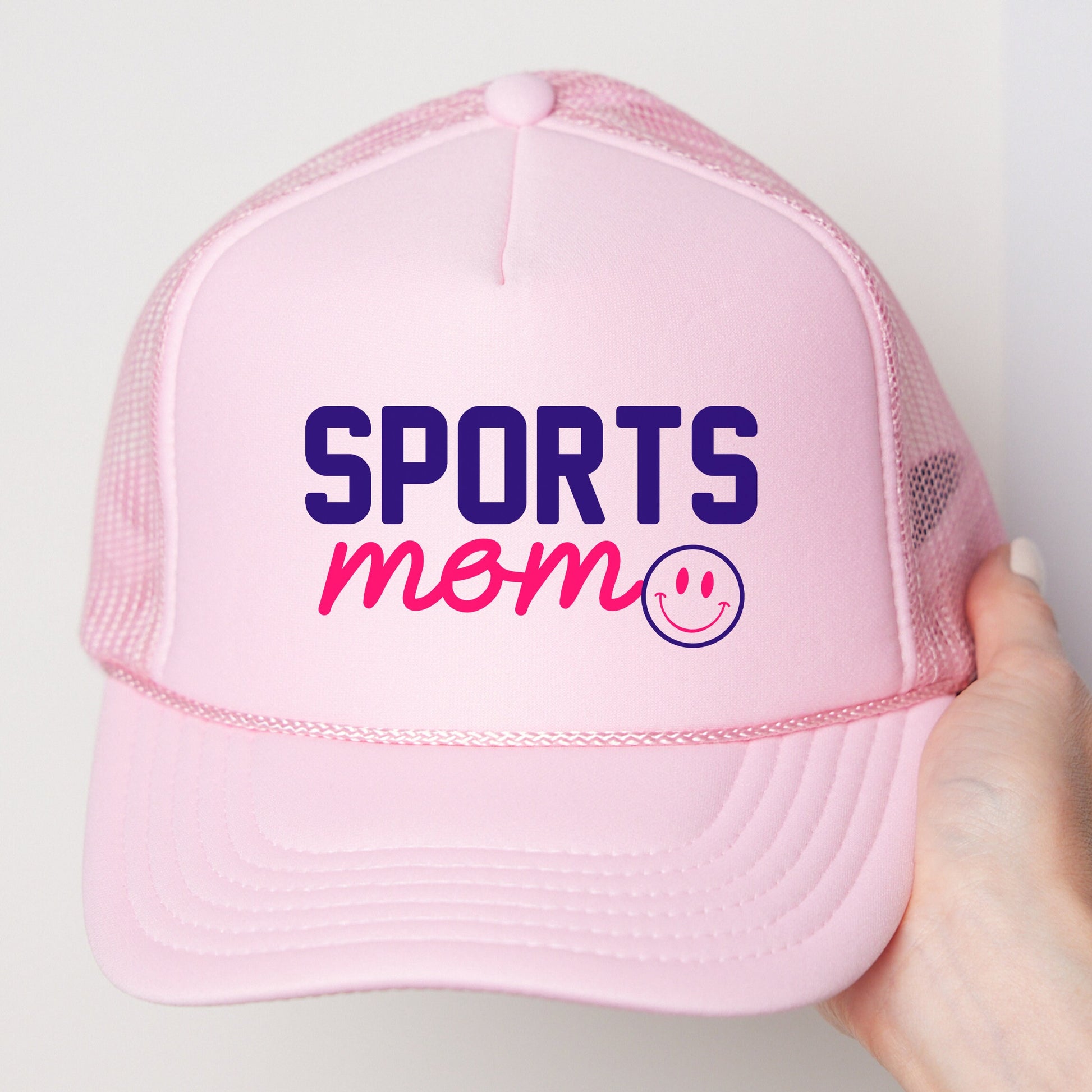 a pink hat with the words sports mom printed on it