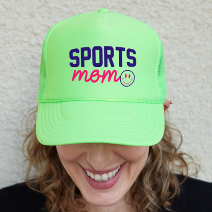 a smiling woman wearing a neon green sports hat