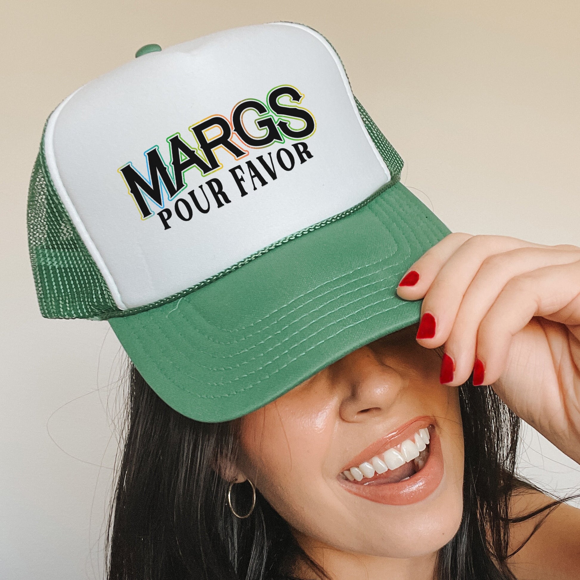 a woman wearing a green and white trucker hat