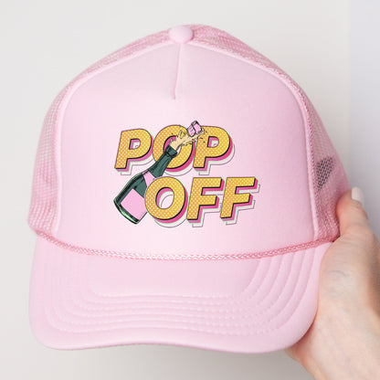a pink hat with a pop off sticker on it