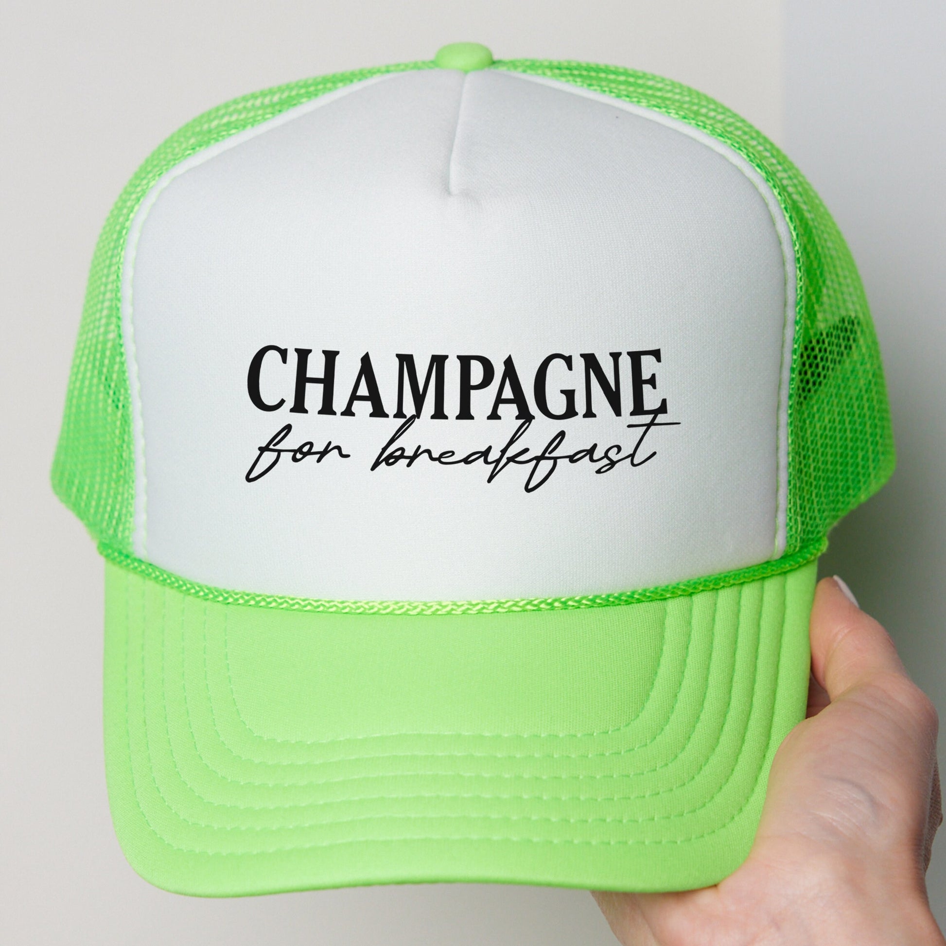 a person holding a green and white hat