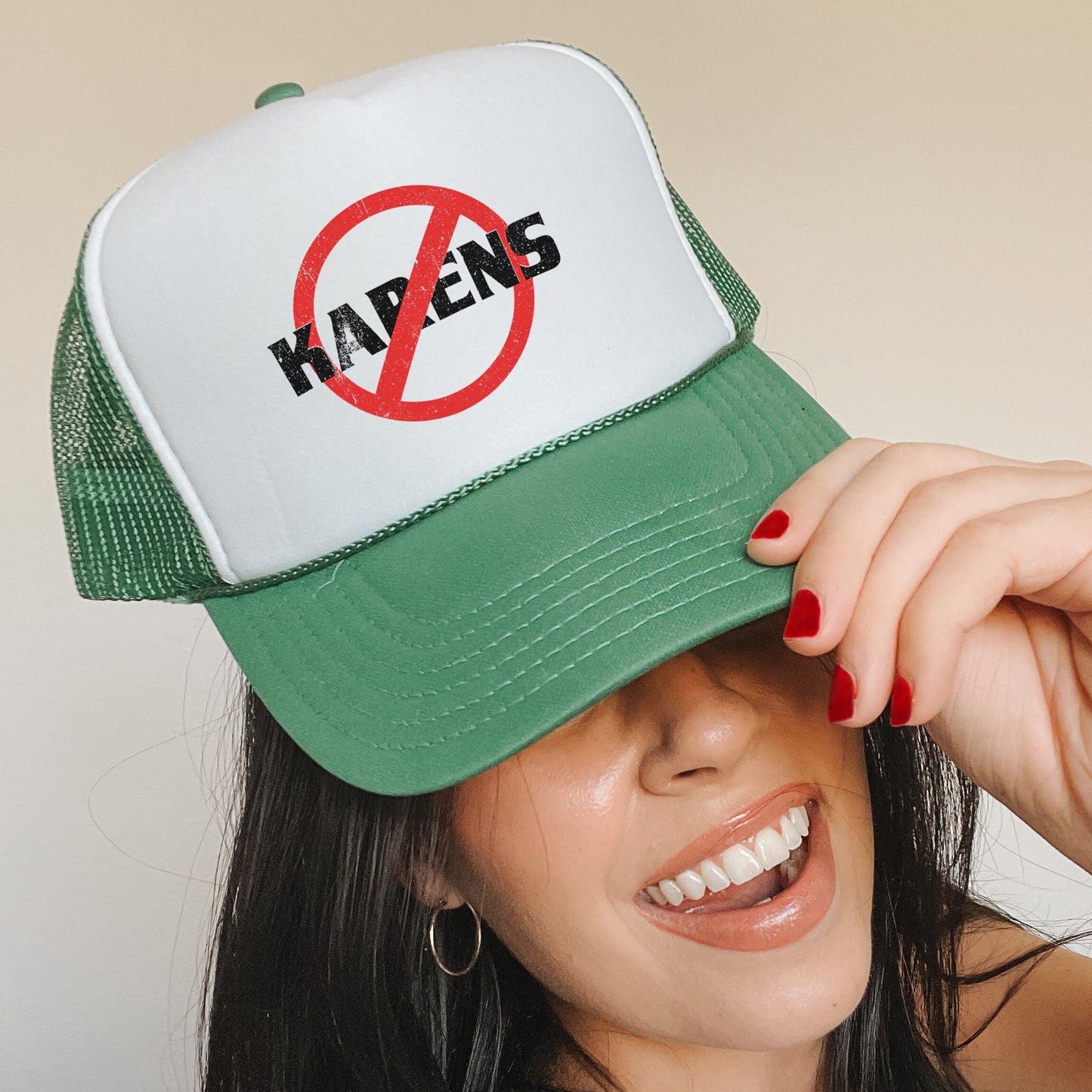 a woman wearing a green and white hat with a no kapen sign on it