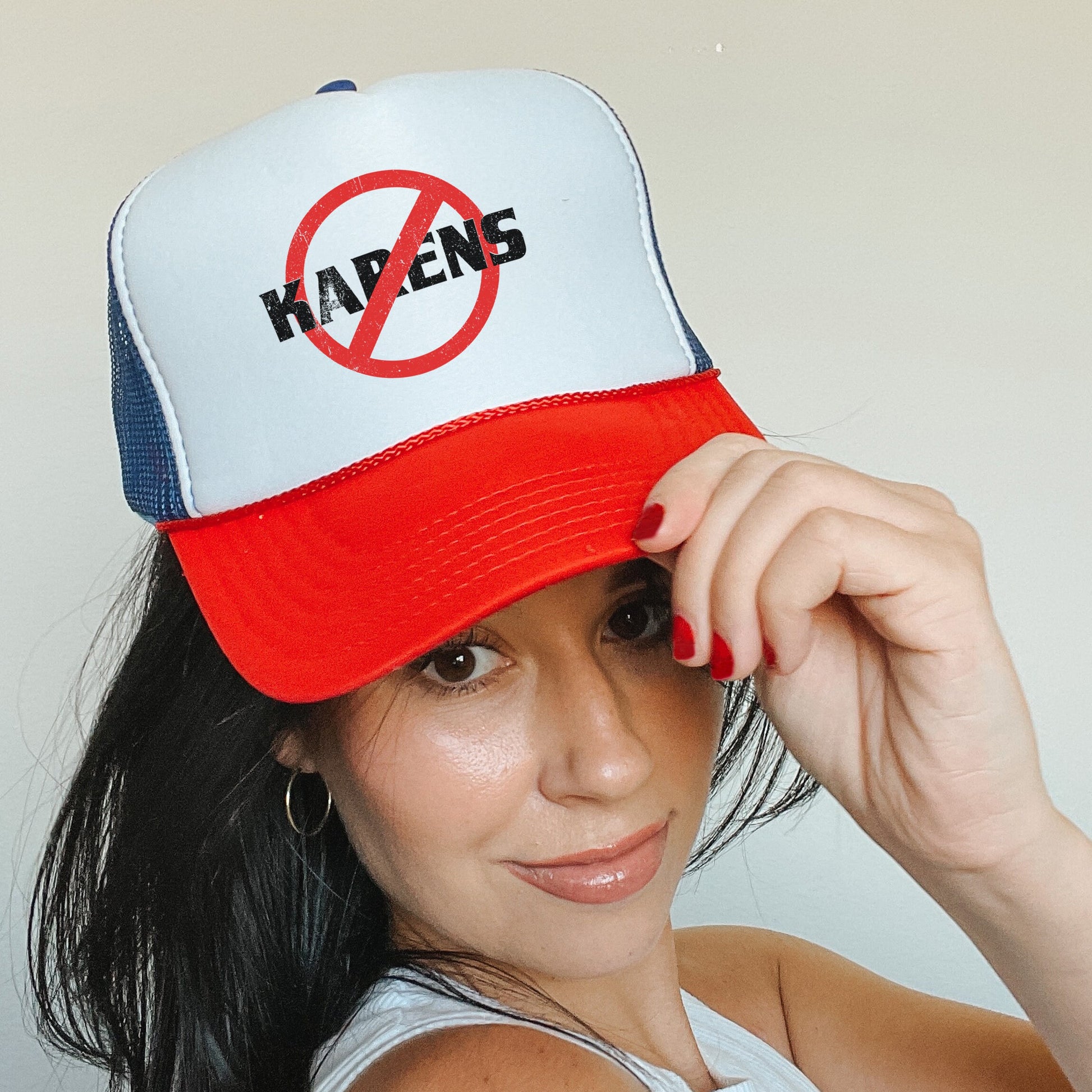 a woman wearing a hat with a no kapen sign on it