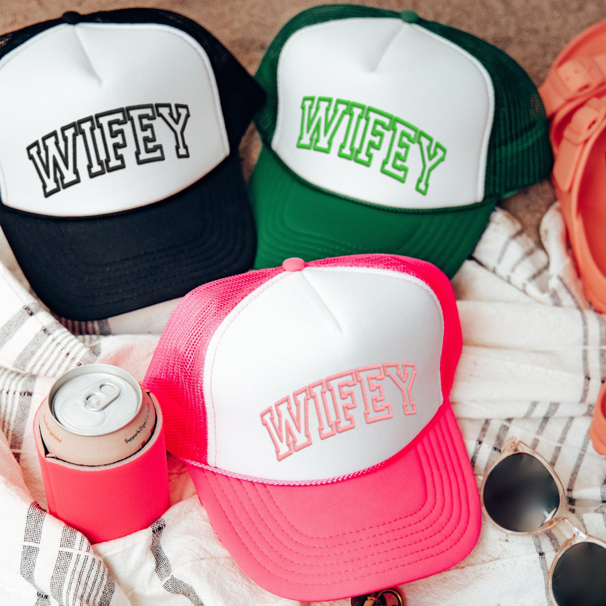 three different colored hats sitting on top of a blanket