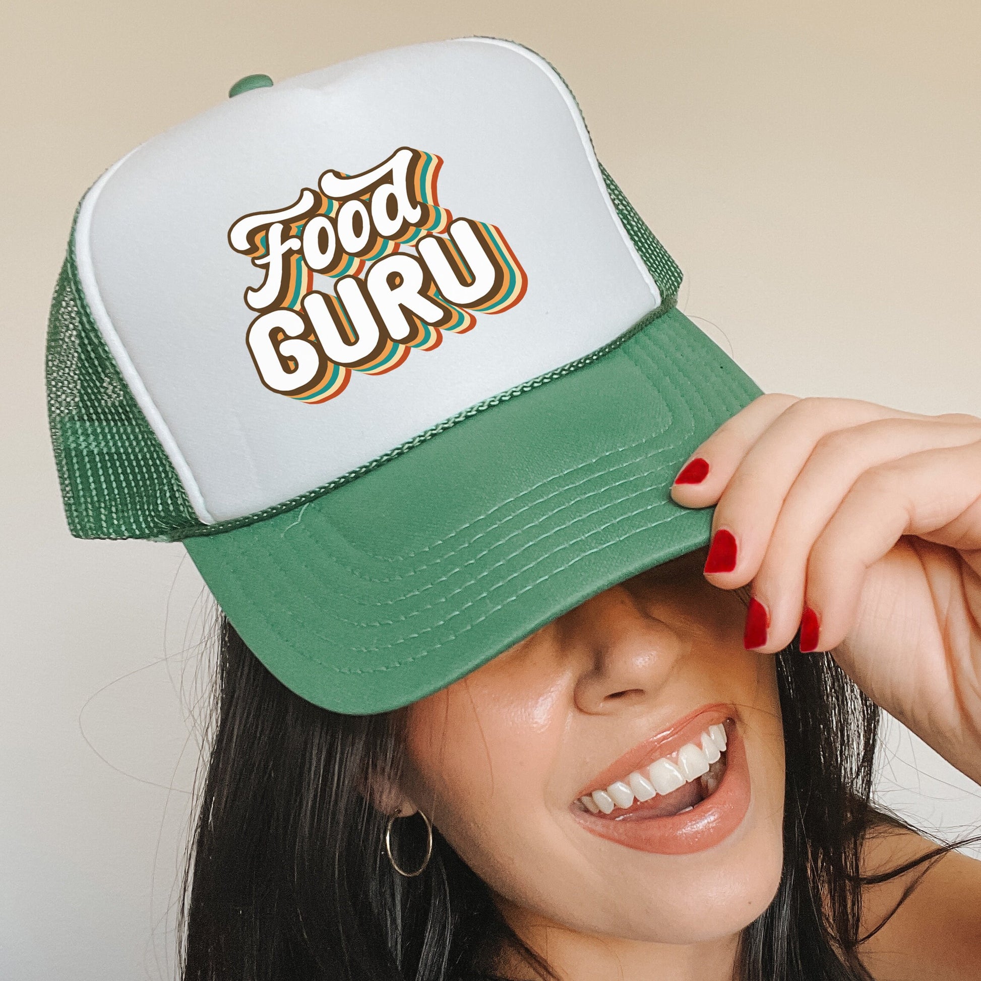 a woman wearing a green and white trucker hat