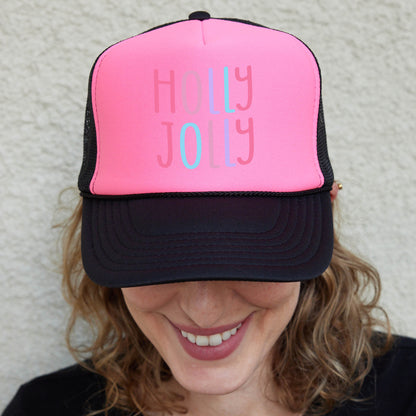 a woman wearing a pink and black trucker hat