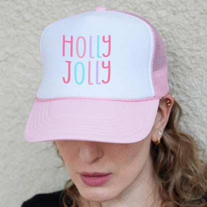 a woman wearing a pink and white trucker hat