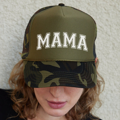 a woman wearing a camo hat with the word mama on it