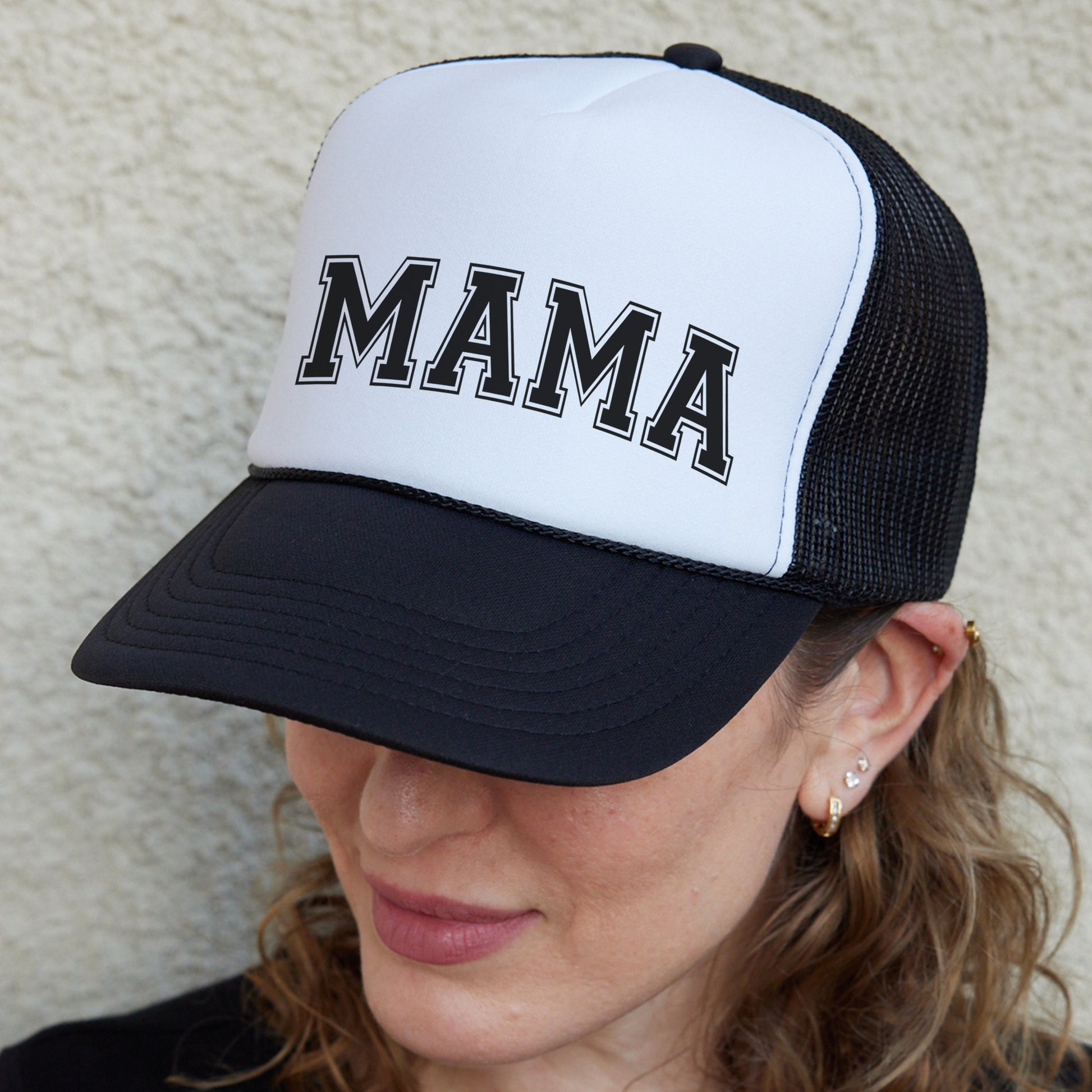 a woman wearing a hat with the word mama on it