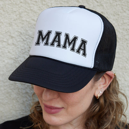 a woman wearing a hat with the word mama on it