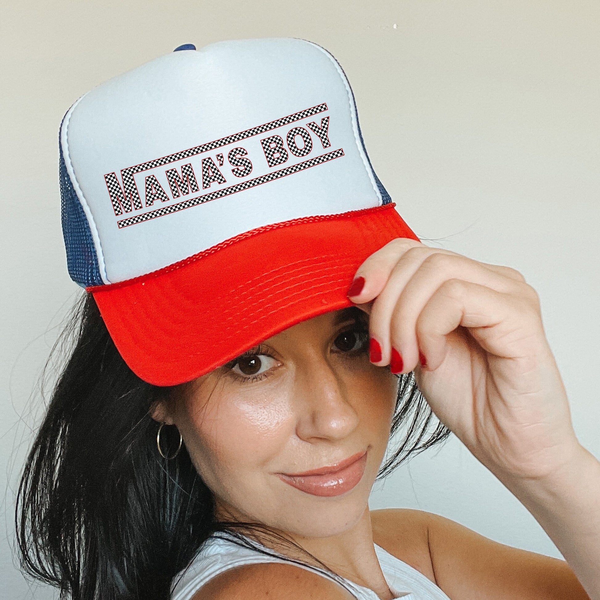 a woman wearing a hat that says namas boy