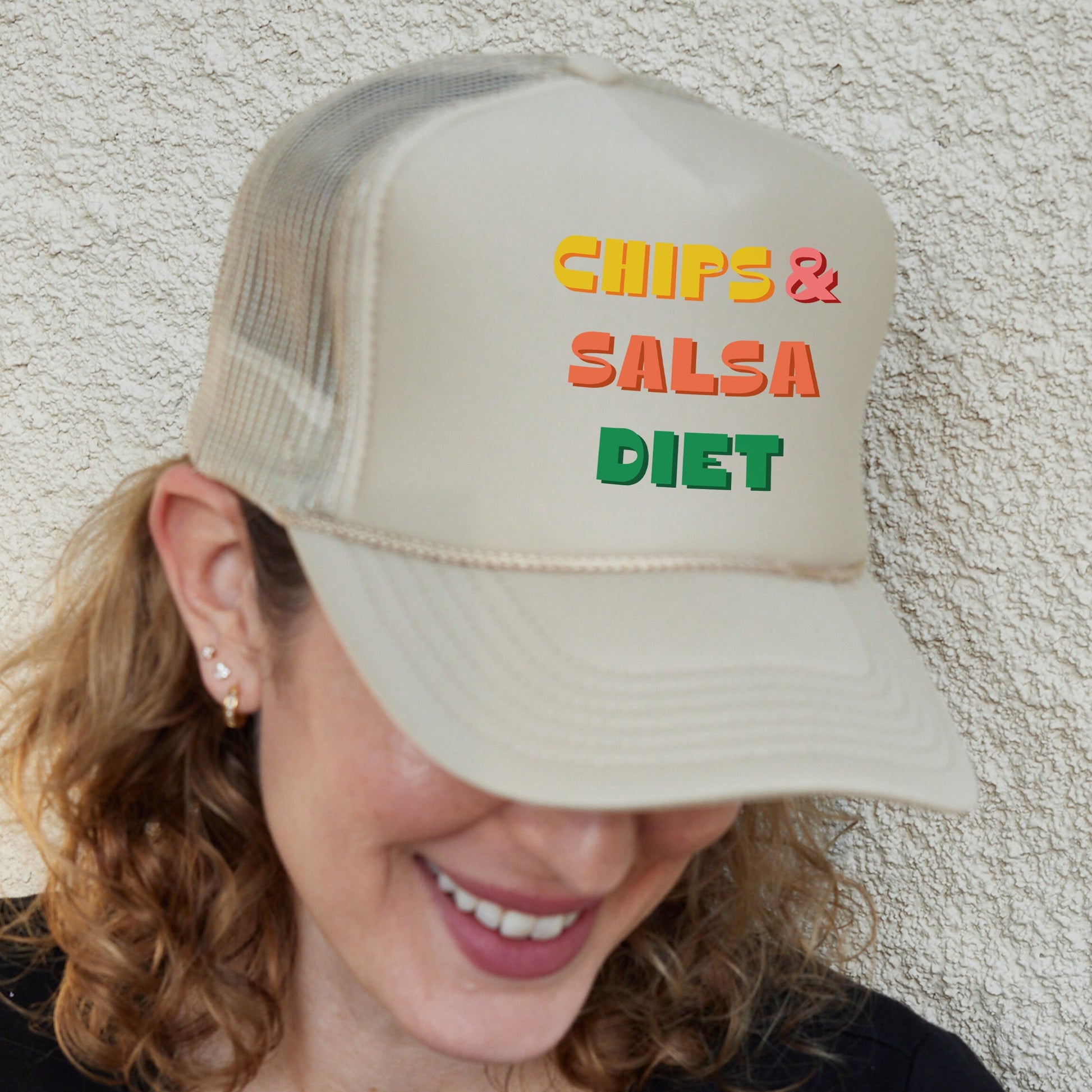 a woman wearing a hat that says chips and salsa diet