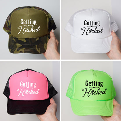 four hats that say getting hitched, getting hitched, getting hitched,