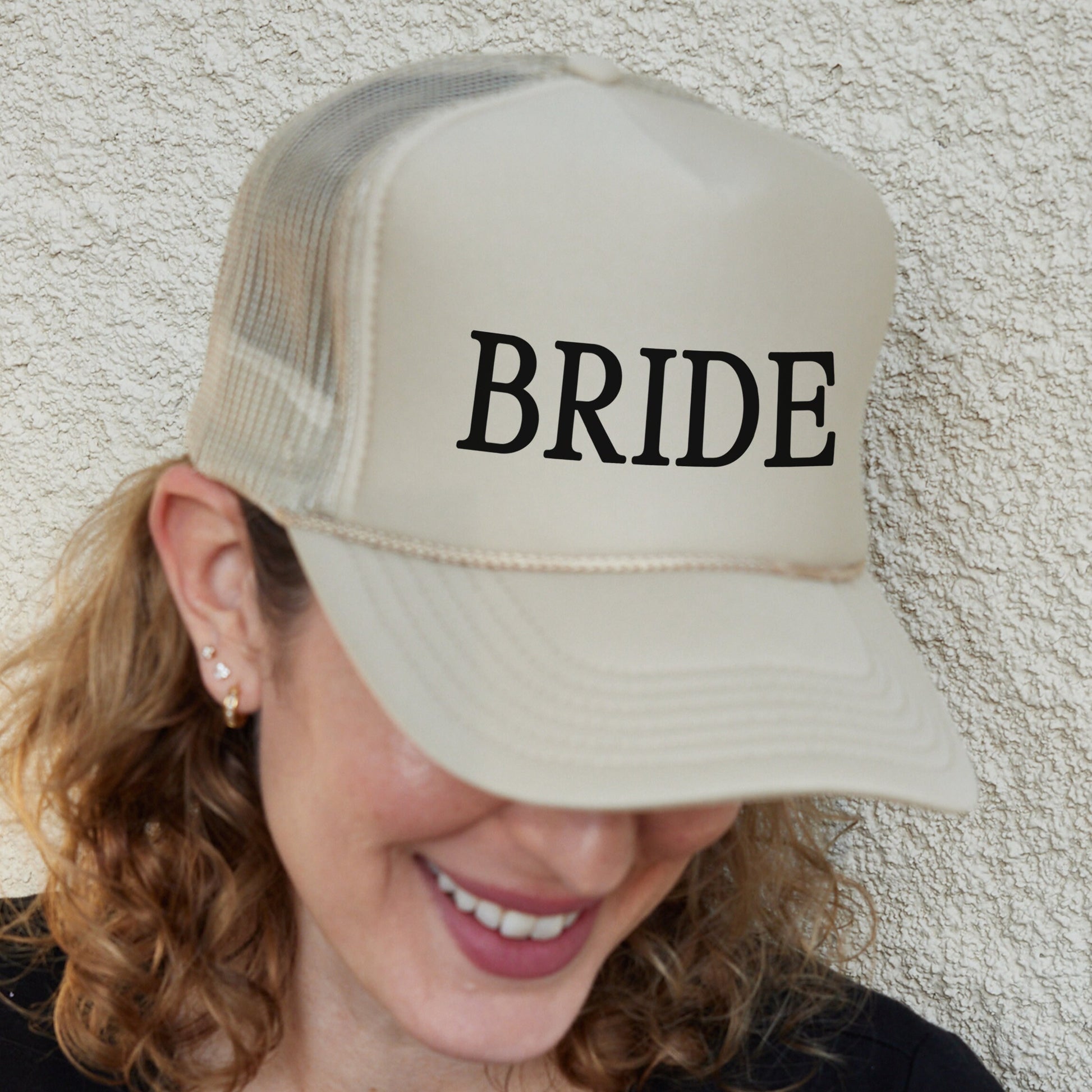 a woman wearing a hat with the word bride on it